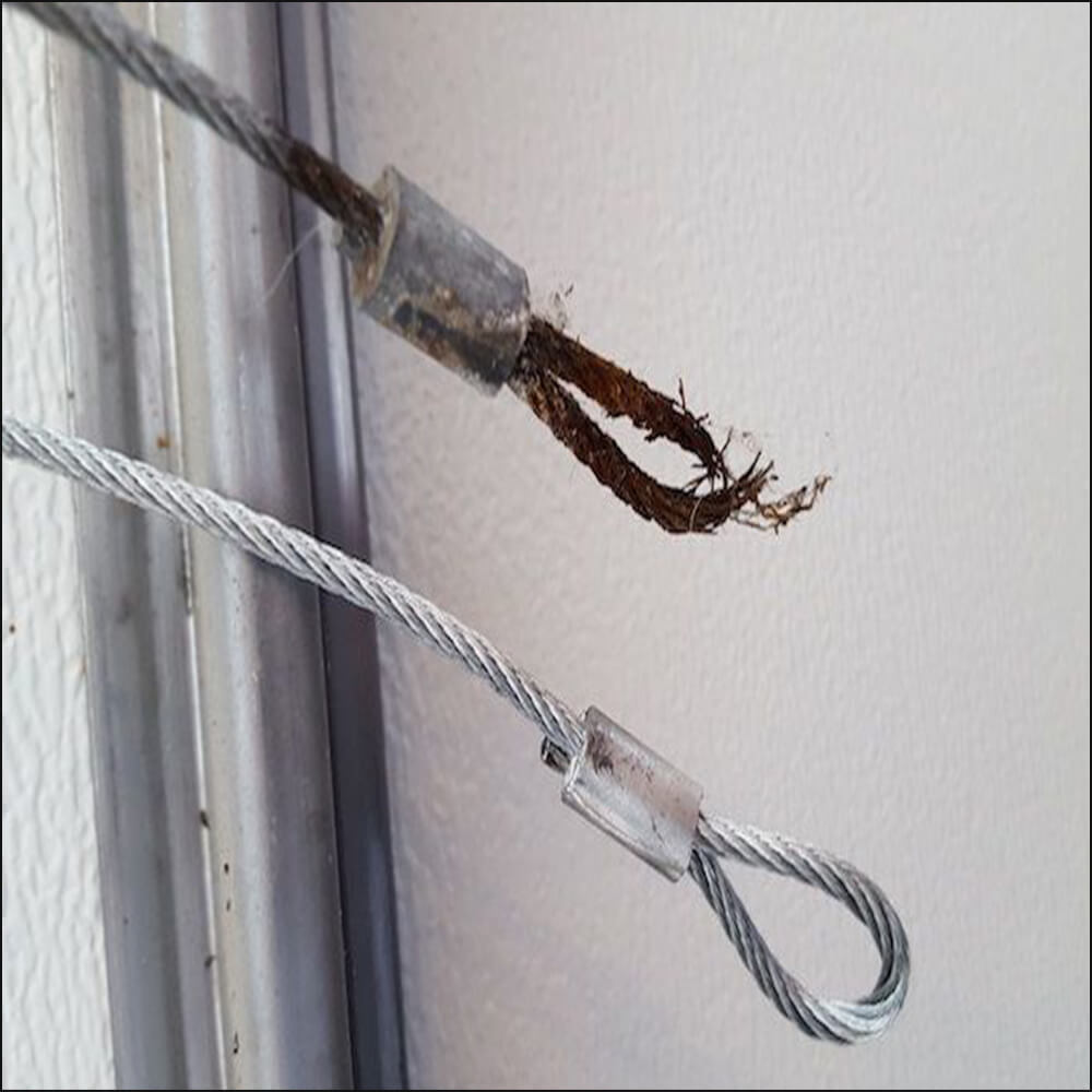 Rust and corrosion on garage door lift cable
